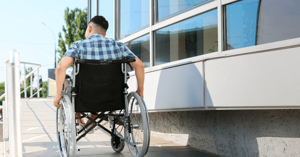 a person in a wheelchair next to an office building