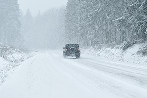 car-driving-through-snow-in-winter