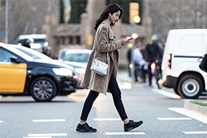 woman-crossing-road-on-cellphone