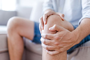 man-massaging-knee-pain